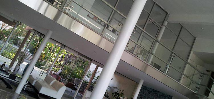 A large, open lobby with a balcony and columns.